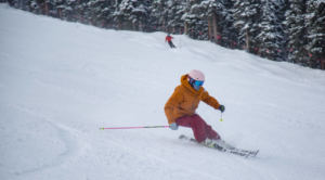 female skiing downhill