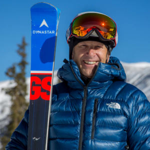 Picture of male skier with skis on a snowy landscape