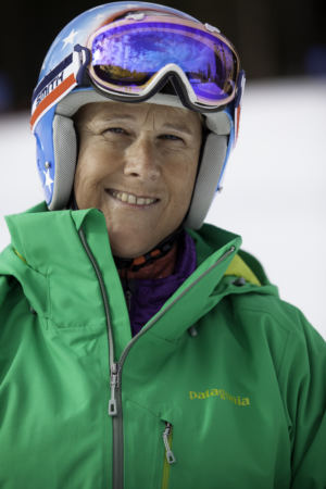 woman in green jacket with helmet and goggles