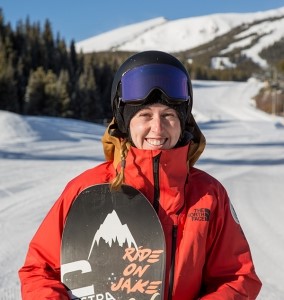 woman snowboarder in a red coat