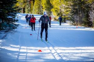 cross country skiers in a line on snow