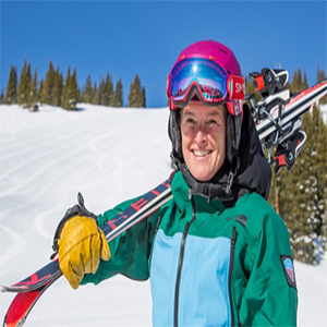 woman holding skis on snowy hill