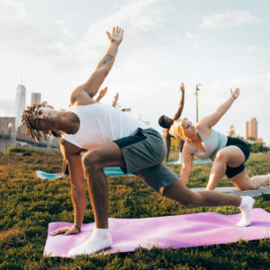 people doing yoga in a park