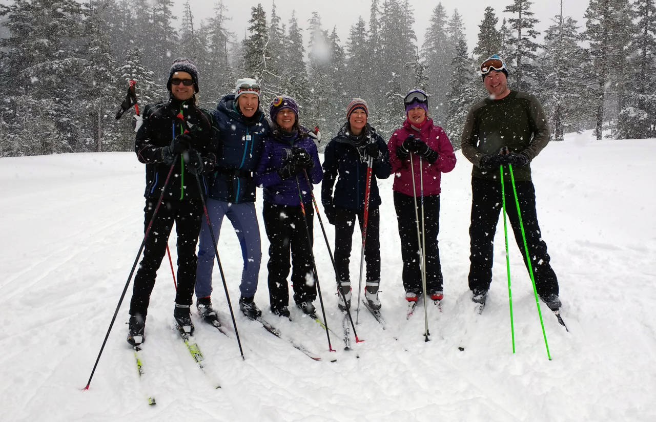 group of people in the snow on skis