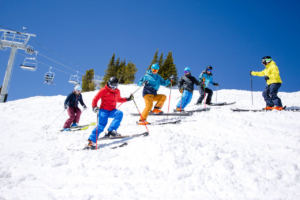 group of skiers side stepping down a hill