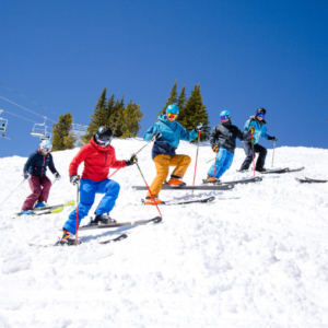 group of skiers side stepping down a hill