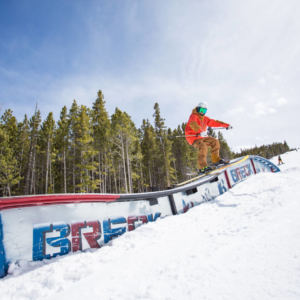 skier sliding sideways down a rail