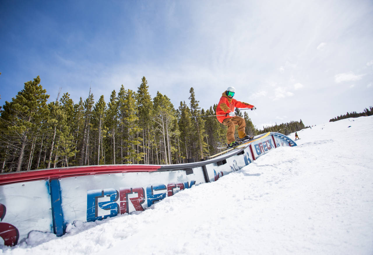 skier sliding sideways down a rail